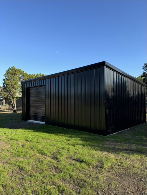 Black steel building photographed at evening, Central Texas
